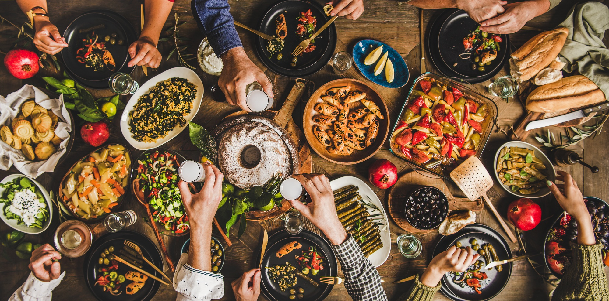 Traditional Turkish celebration dinner with food and raki, wide composition