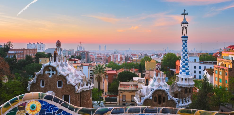 Barcelona city view from Guell Park. Sunrise view of colorful mosaic building in Park Guell