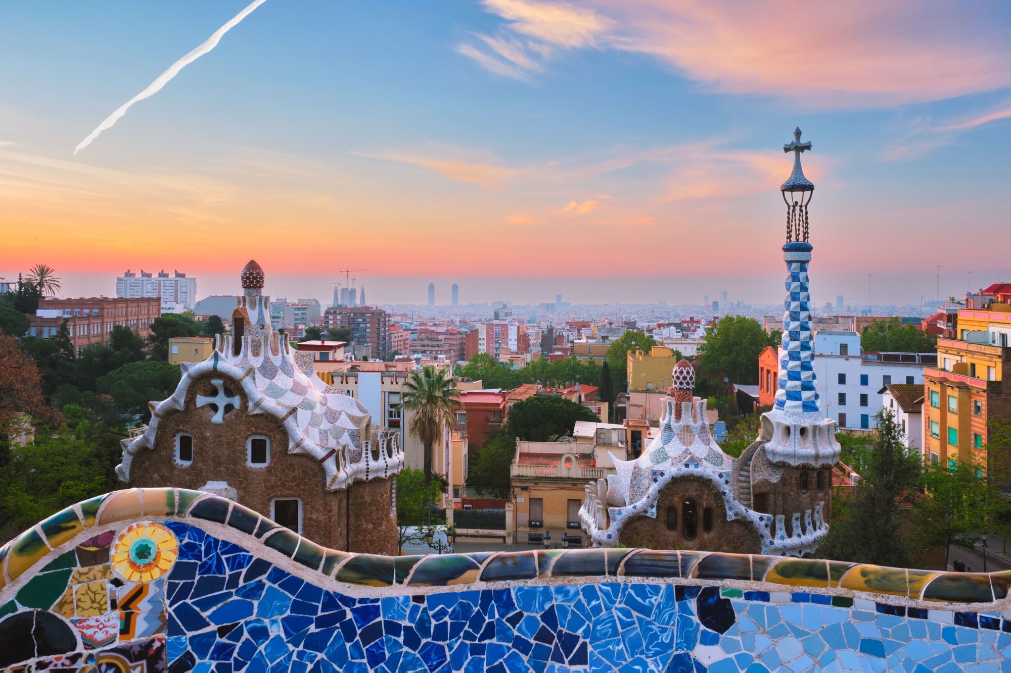 Barcelona city view from Guell Park. Sunrise view of colorful mosaic building in Park Guell