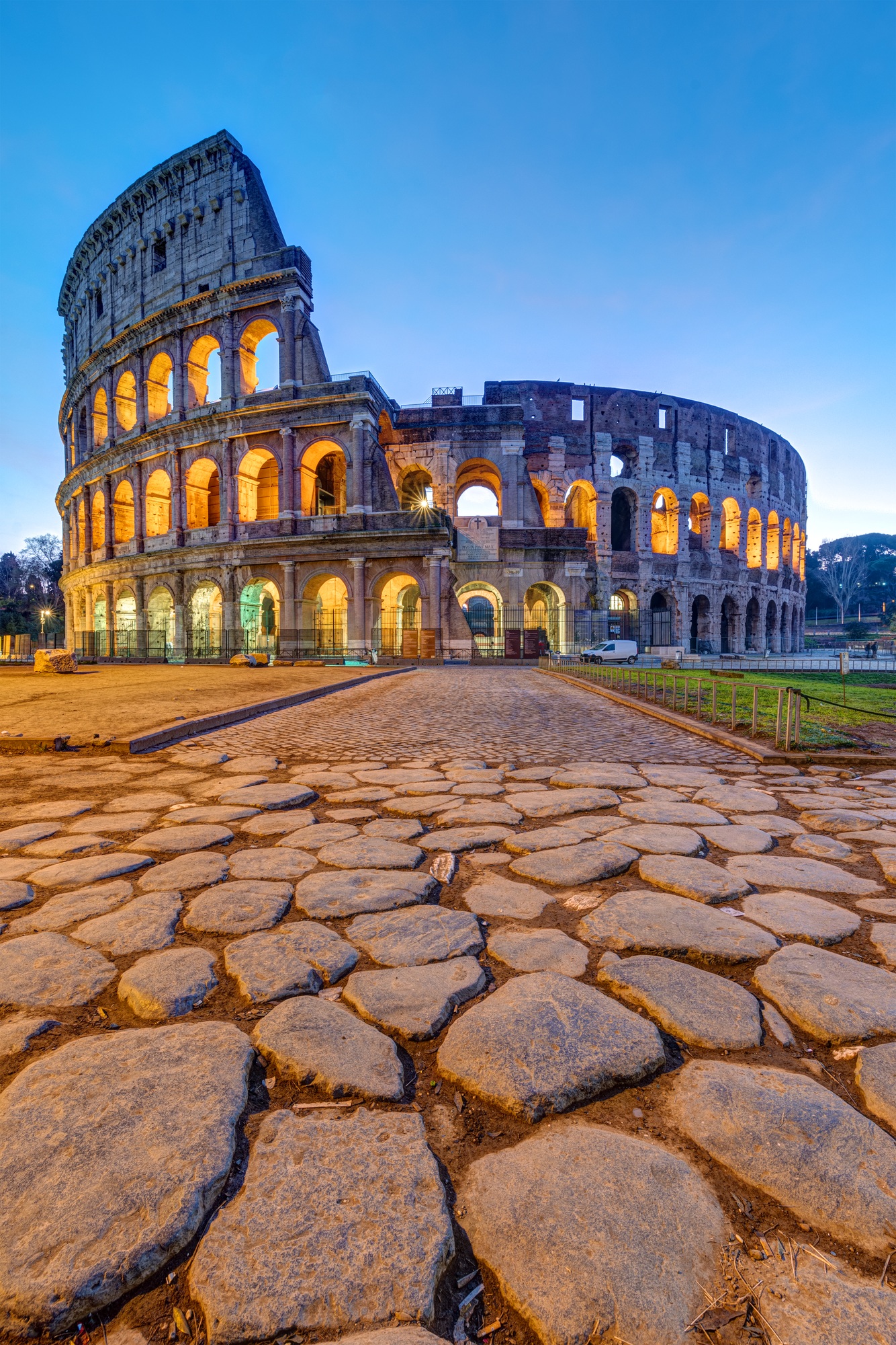 The illuminated Colosseum in Rome at dawn